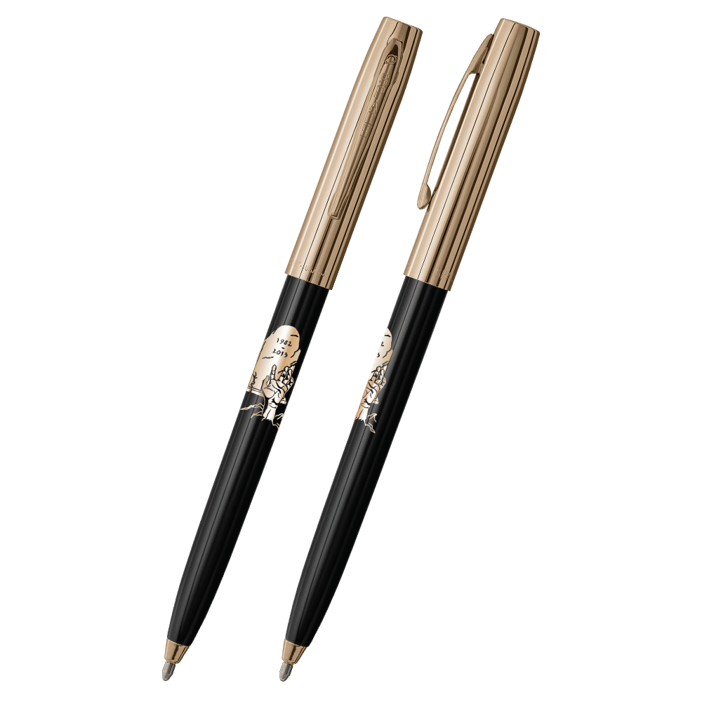Front and side views of cap-o-matic space pen with black plastic barrel, gold cap with clip, gold tip, and imprinted gold headstone and zombie hand.